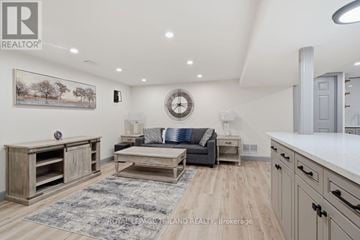 St. Thomas apartment for rent - A well-lit living room with a grey sofa and wooden furniture.