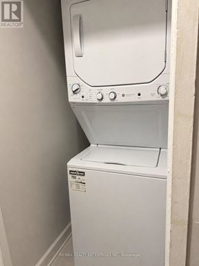Hamilton (Durand) apartment for rent - A white dryer and washer are in a small room.