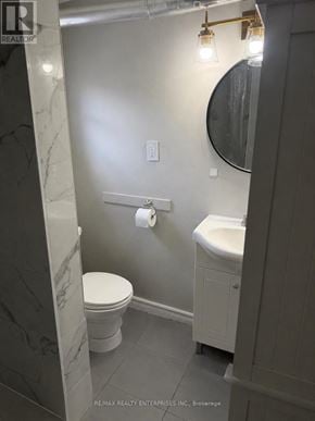 Hamilton (Durand) apartment for rent - A bathroom with a toilet, sink, and mirror.
