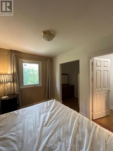 Markham (Bullock) apartment for rent - A bedroom with a bed in the foreground and a window with curtains.