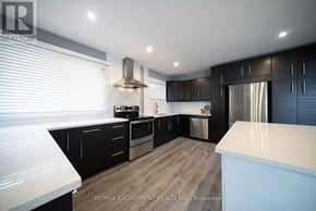 Cambridge apartment for rent - A modern kitchen with black cabinets and stainless steel appliances.