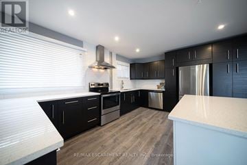 Cambridge apartment for rent - A modern kitchen with black cabinets and stainless steel appliances.