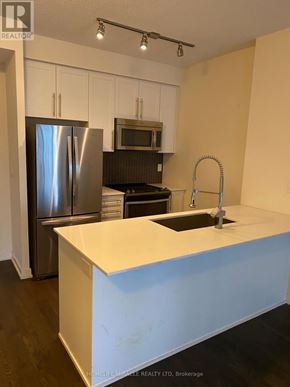 Mississauga (City Centre) condo for rent - A kitchen with a sink and a refrigerator.