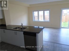 Thorold (Rolling Meadows) townhouse for rent - A kitchen with a sink and cabinets.