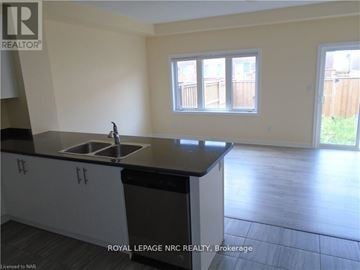 Thorold (Rolling Meadows) townhouse for rent - A kitchen with a sink and cabinets.