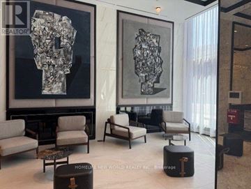 Toronto (Bay Street Corridor) condo for rent - A living room with a large sculpture on the wall and a coffee table in the center.
