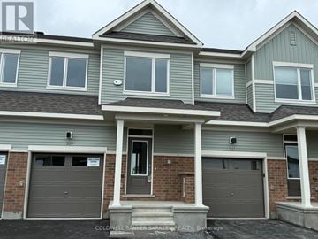 Ottawa townhouse for rent - A two-story house with a garage is for sale.