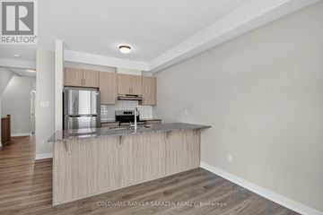 Ottawa townhouse for rent - A modern kitchen with wooden cabinets and a stainless steel refrigerator.