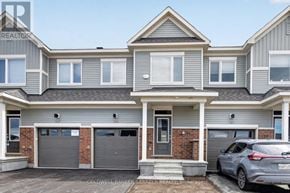 Ottawa townhouse for rent - A two-story house with a grey and white exterior and a grey car parked in front.
