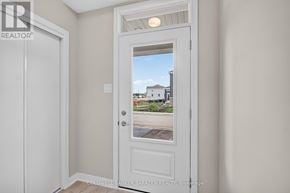 Ottawa townhouse for rent - A white door with a view of a house and trees outside.