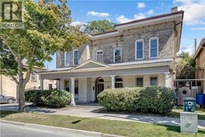 Brantford apartment for rent - A house with a front yard and a tree.