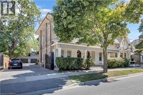 Brantford apartment for rent - A house with a tree in front of it.