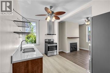 Brantford apartment for rent - A modern kitchen with a stainless steel oven and a wood-burning stove.