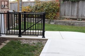 Brampton (Northwest Sandalwood Parkway) apartment for rent - A black metal fence in front of a brick wall.