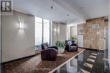 Toronto (Church-Yonge Corridor) condo for rent - A living room with a brown couch and a plant.