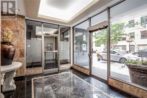 Toronto (Church-Yonge Corridor) condo for rent - A realtor's office with a glass door and a plant on the table.