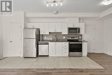 Ottawa condo for rent - A kitchen with white cabinets and appliances is on the market with RE/MAX Hallmark Realty Group.