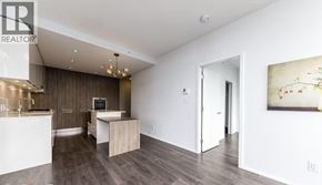 Burnaby apartment for rent - A modern kitchen with a dining area and a painting on the wall.