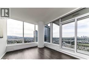 Burnaby apartment for rent - A room with a large window overlooking a cityscape.