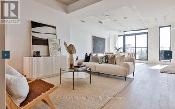 Toronto (Trinity-Bellwoods) condo for rent - A living room with a white couch and a coffee table.