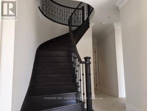 Richmond Hill (Oak Ridges) apartment for rent - A black spiral staircase with a wooden handrail.