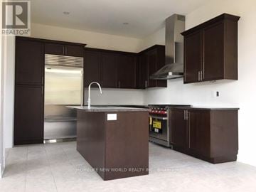 Richmond Hill (Oak Ridges) apartment for rent - A kitchen with dark brown cabinets and a stainless steel refrigerator.