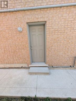 Brampton (Bram East) apartment for rent - A grey door is on a brick wall.