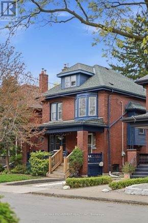 Hamilton (Stipley) apartment for rent - A brick house with a blue trim and a green roof.