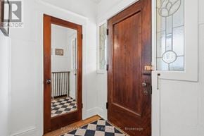 Hamilton (Stipley) apartment for rent - A hallway with a checkered floor and a wooden door.