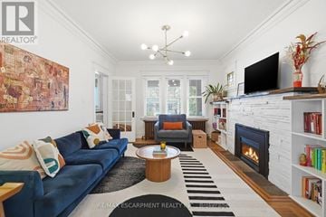 Hamilton (Stipley) apartment for rent - A living room with a blue couch and a fireplace.