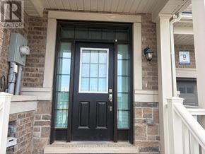 Whitby townhouse for rent - A black door with a glass window is on the front of a house.