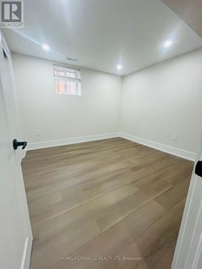 Ajax (Central) apartment for rent - A room with wooden flooring and white walls.