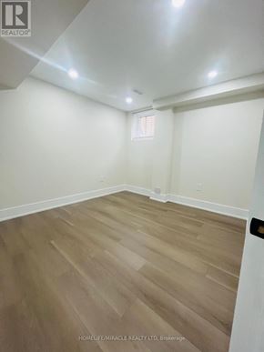 Ajax (Central) apartment for rent - A room with wooden flooring and white walls.