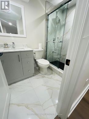 Ajax (Central) apartment for rent - A bathroom with a toilet, sink, and shower.