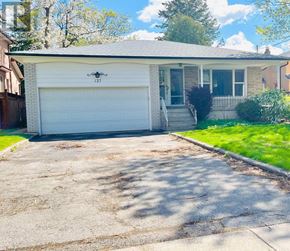 Toronto (Willowdale East) apartment for rent - A house with a garage and a driveway in front.