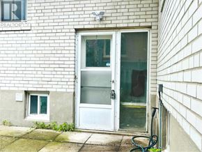 Toronto (Willowdale East) apartment for rent - A white door with a glass window is on the side of a building.