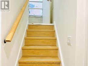 Toronto (Willowdale East) apartment for rent - A staircase with wooden steps and a wooden handrail.