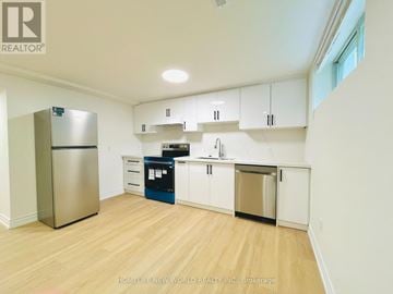 Toronto (Willowdale East) apartment for rent - A kitchen with white cabinets and a wooden floor.