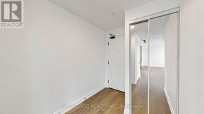 Toronto (Forest Hill South) condo for rent - A room with a white wall and a wooden floor.