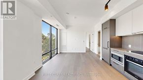 Toronto (Forest Hill South) condo for rent - A modern kitchen with a view of trees outside the window.