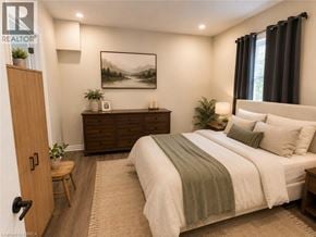 Brantford apartment for rent - A bedroom with a bed, nightstand, and a painting on the wall.