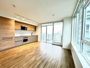 Surrey apartment for rent - A spacious kitchen with wooden floors and a modern design.