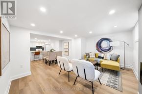 Newmarket (Central Newmarket) apartment for rent - A living room with a yellow couch and a white chair.