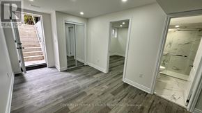 Brampton (Bram East) apartment for rent - A spacious room with wooden flooring and white walls.