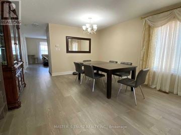 Mississauga (Churchill Meadows) apartment for rent - A dining room with a wooden table and chairs.
