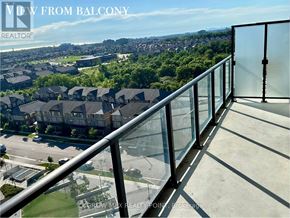 Oakville (Jm Joshua Meadows) condo for rent - A balcony with a glass railing overlooking a residential area.