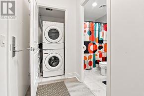 Toronto (Mimico) condo for rent - A white washer and dryer are in a small laundry room.