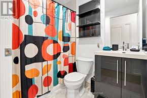 Toronto (Mimico) condo for rent - A bathroom with a toilet, sink, and shower curtain.