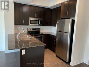 Toronto (Downsview-Roding-Cfb) condo for rent - A kitchen with a granite countertop and stainless steel appliances.