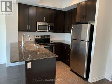 Toronto (Downsview-Roding-Cfb) condo for rent - A kitchen with a granite countertop and stainless steel appliances.